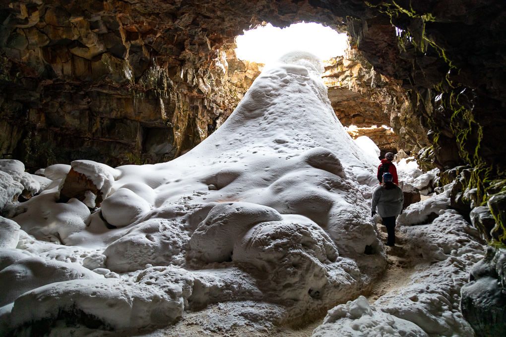 Sunlight illuminates a narrow rocky cave passage at Raufarhólshellir lava tunnel in Iceland.