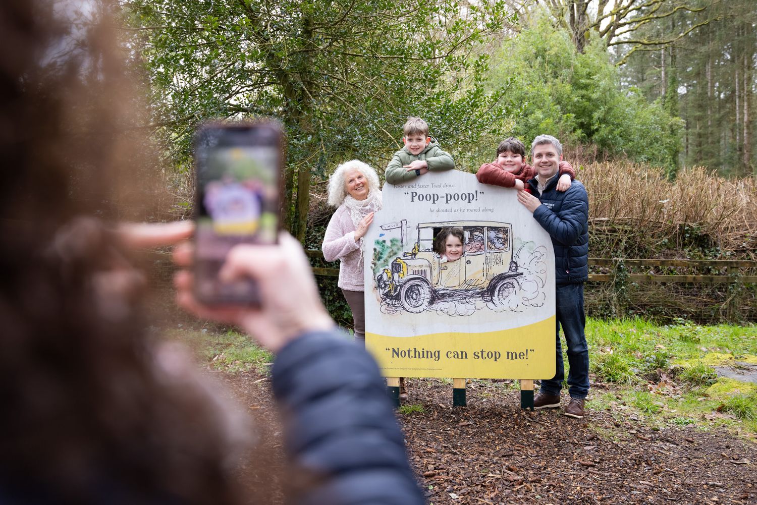 Family exploring the Wind in the Willows trail at RHS Rosemoor during a visitor attraction lifestyle photography shoot