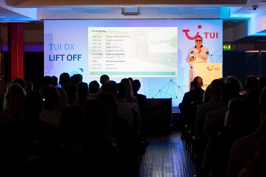 London conference photography of a dark silhouette of a conference audience watching a TUI presentation.