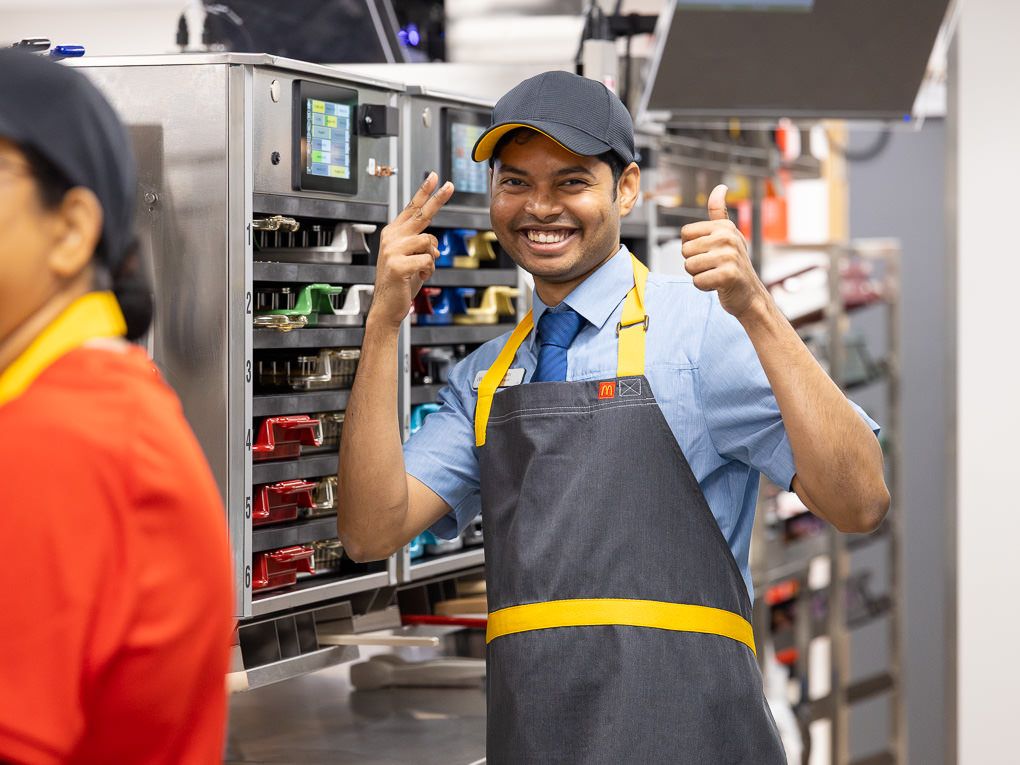 McDonald’s crew member giving a thumbs up in the kitchen at the Rickmansworth restaurant opening, photographed for PR and press use.