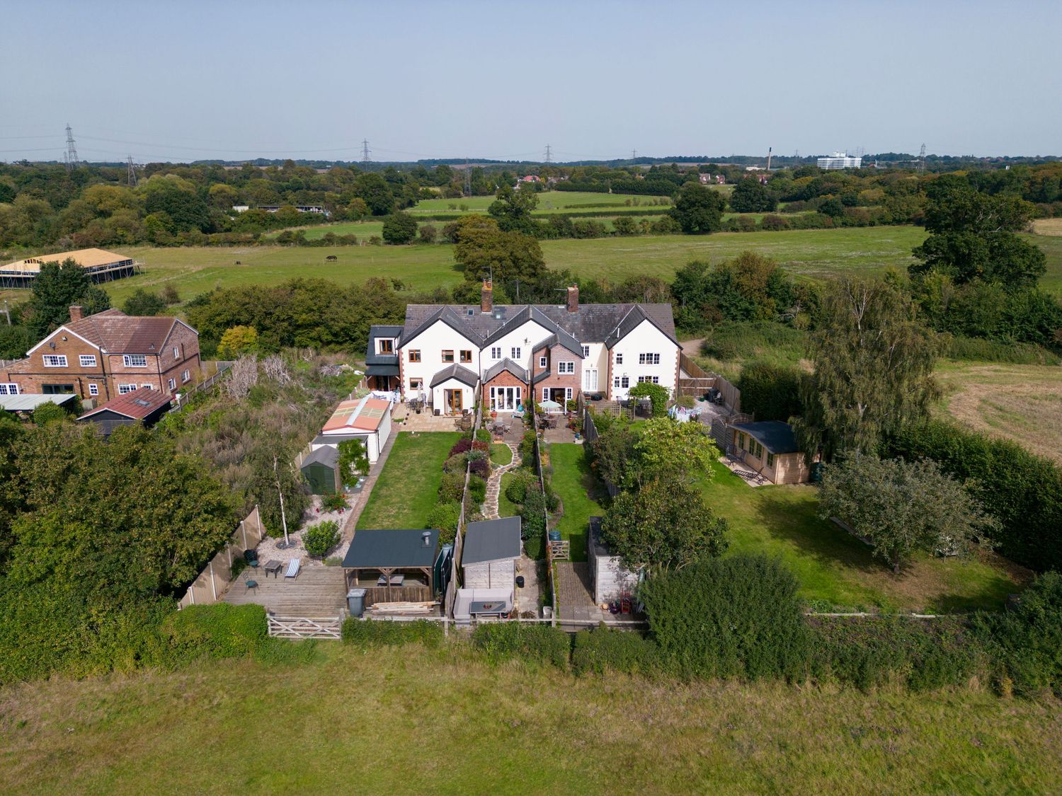 Aerial property photography of countryside home with extensive grounds, mature trees and surrounding rural landscape.