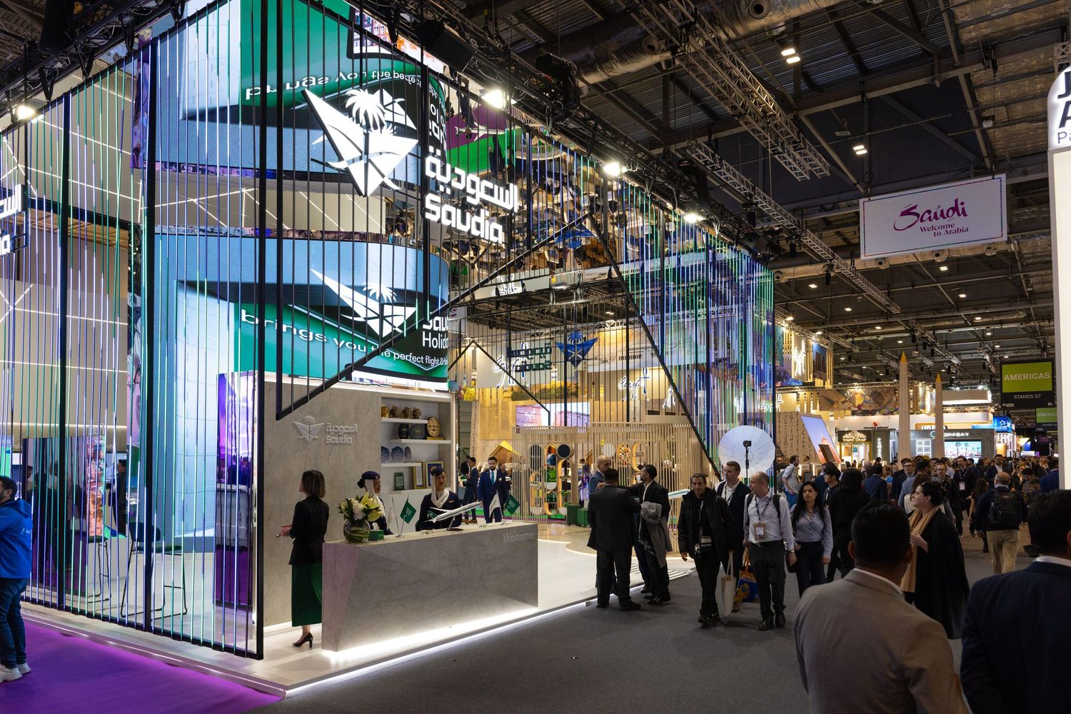 Visitors exploring the Saudi Arabia tourism stand at an international travel and tourism exhibition