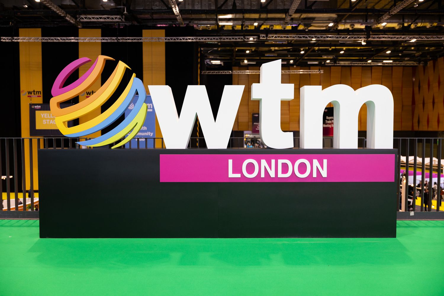 World Travel Market exhibition booth displays with WTM London branding and colourful signage in a convention hall.