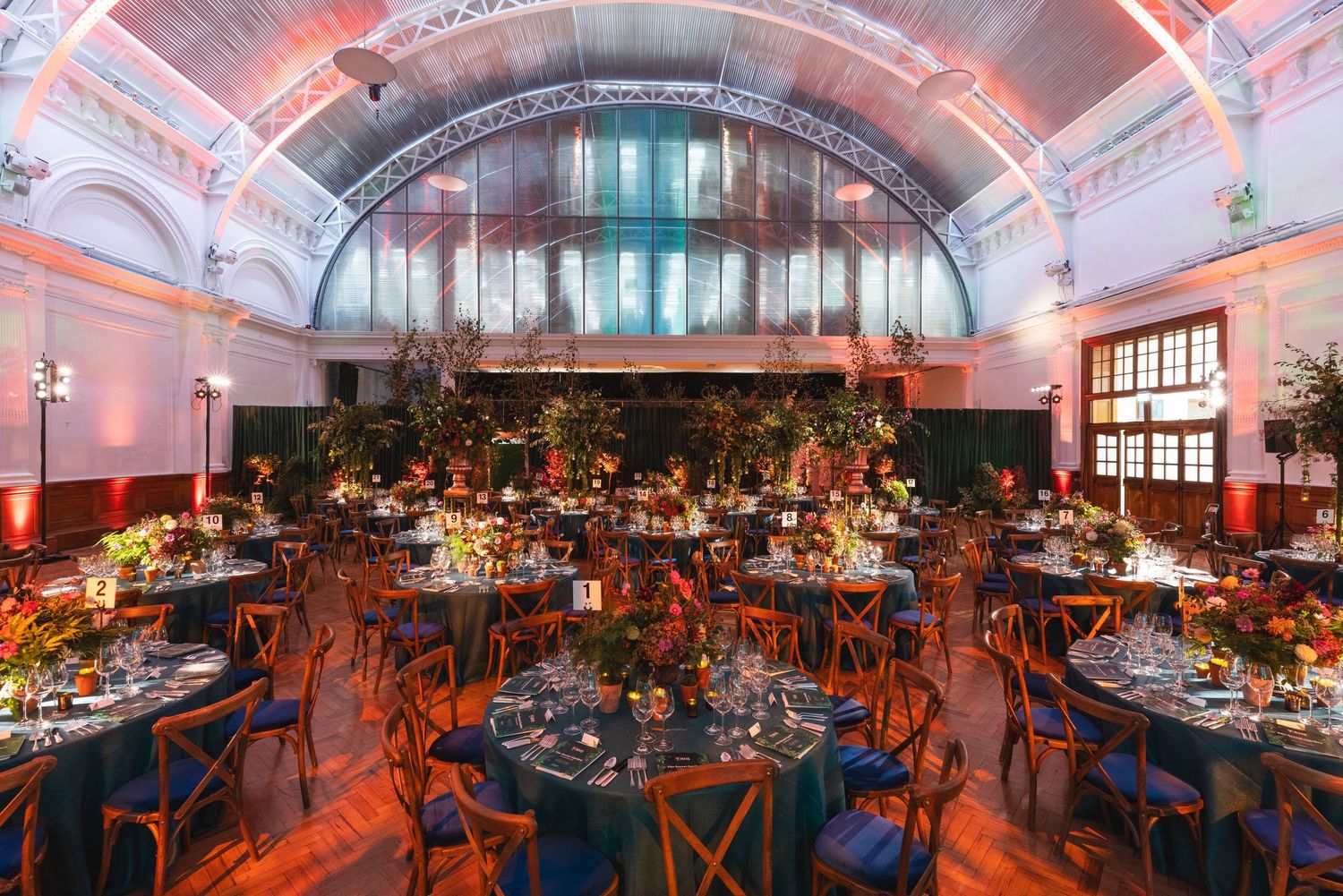 Elegant banquet hall prepared for a corporate awards ceremony with formal dining tables and event lighting