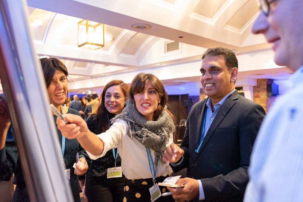 Business professionals are networking and mingling at a corporate event with drinks and refreshments at a conference in London.