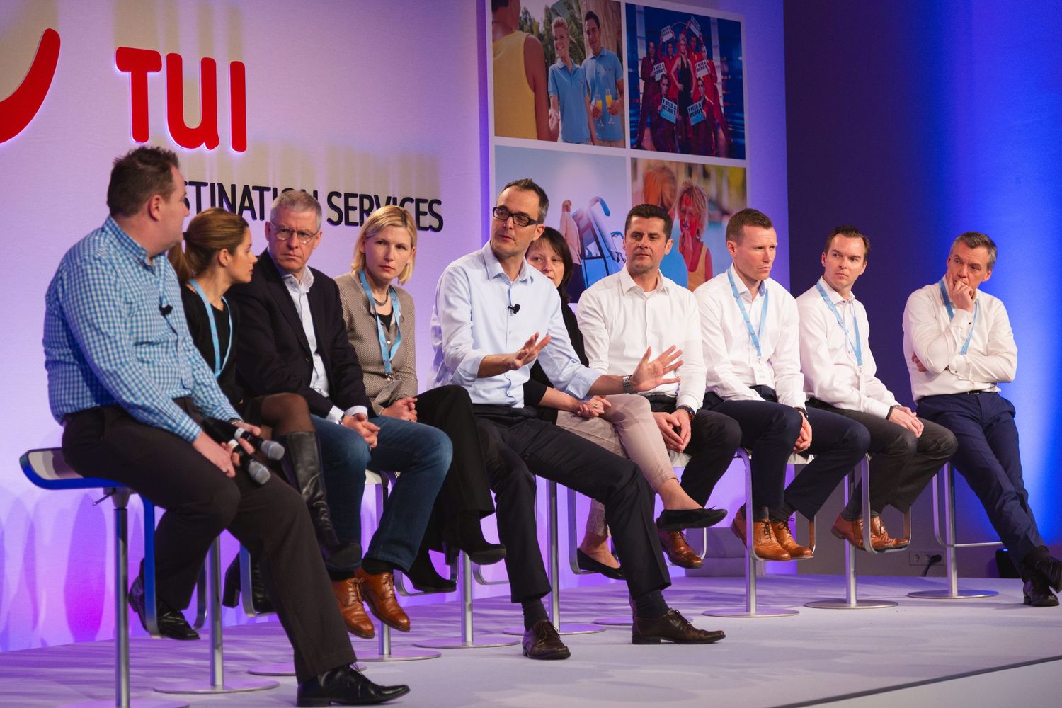 Panel discussion taking place on stage at a TUI  conference with industry professionals