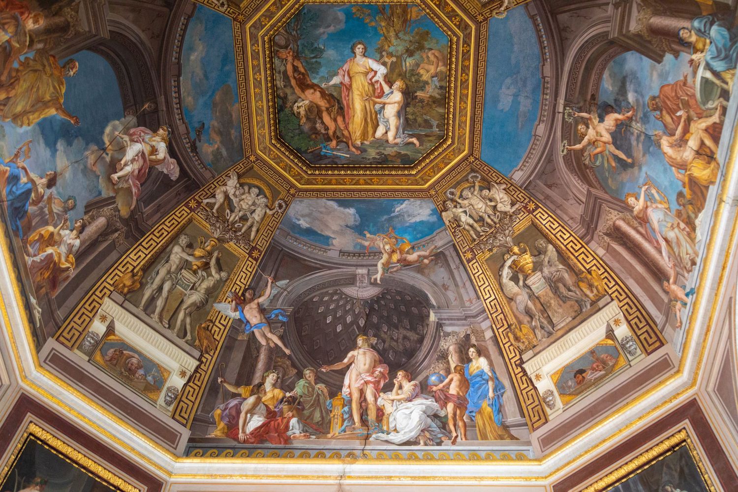 Architectural interior photography of ornate Vatican Museums ceiling featuring Renaissance artwork and decorative detail.