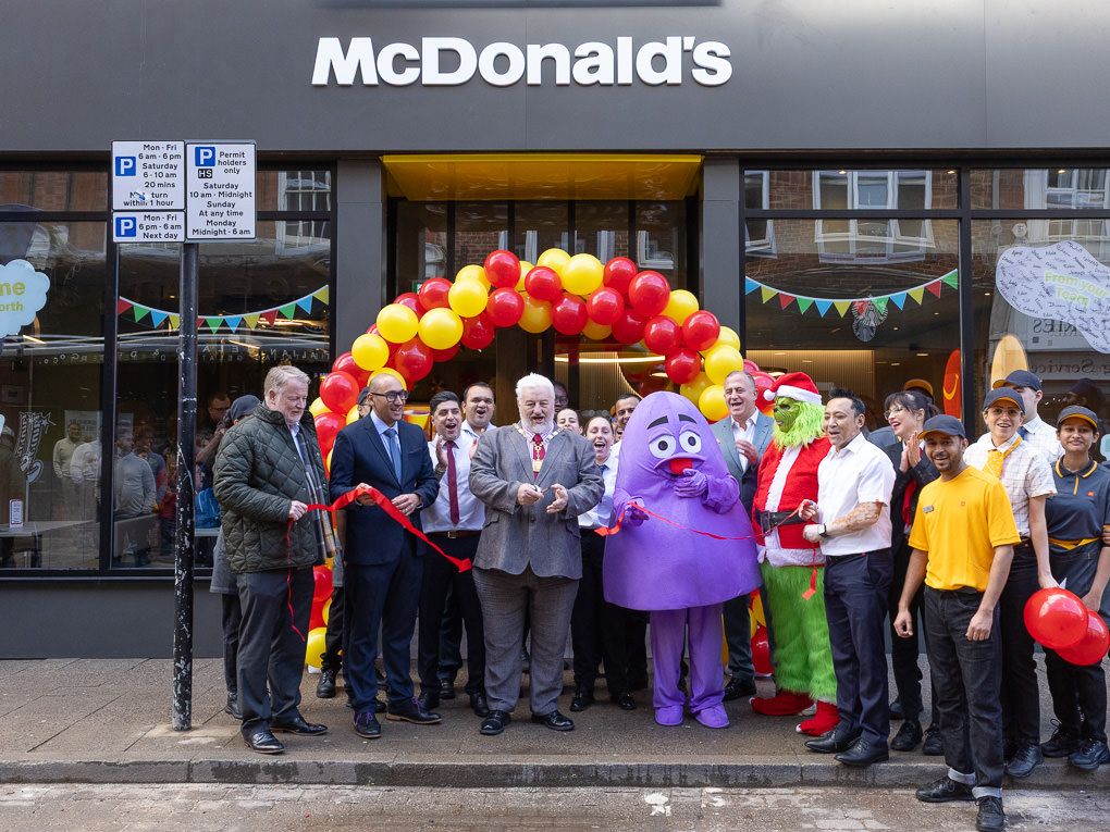 PR photography of McDonald’s restaurant opening with staff and mascots outside the Rickmansworth location, featuring branded balloons and te