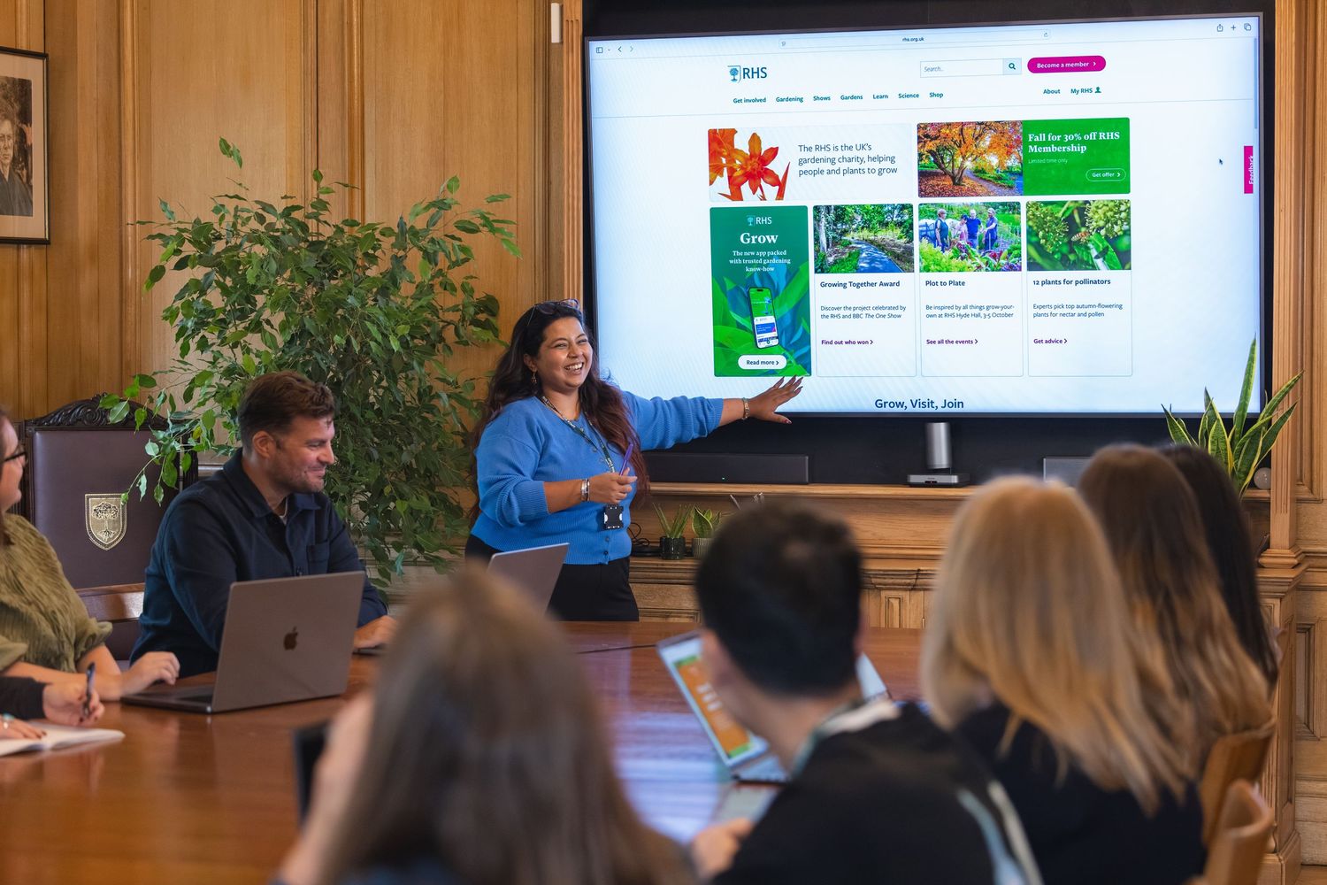 RHS staff photoshoot in Victoria, London. People gather in a conference room for a meeting.