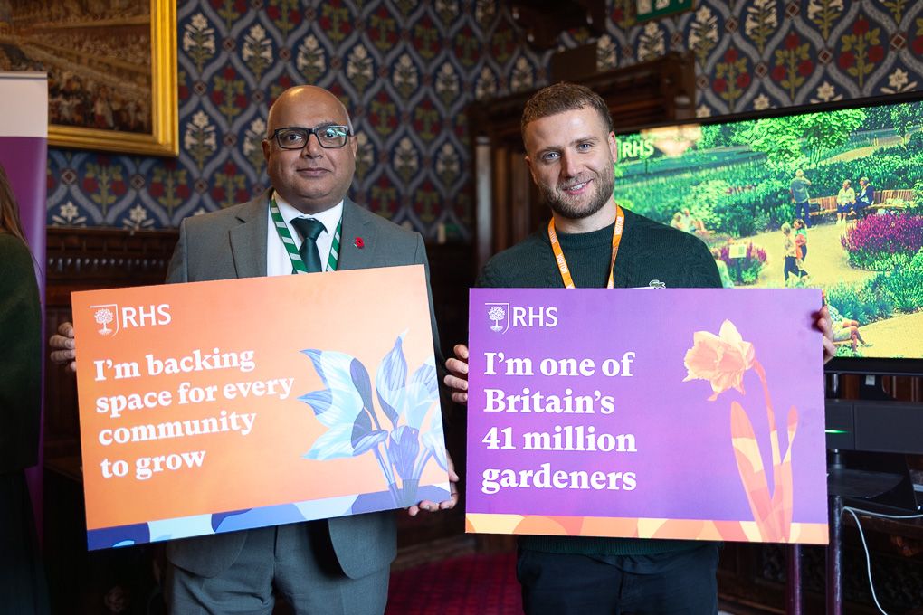MP Baggy Shanker holding up a colourful RHS board at a conference event in the Houses of Parliament