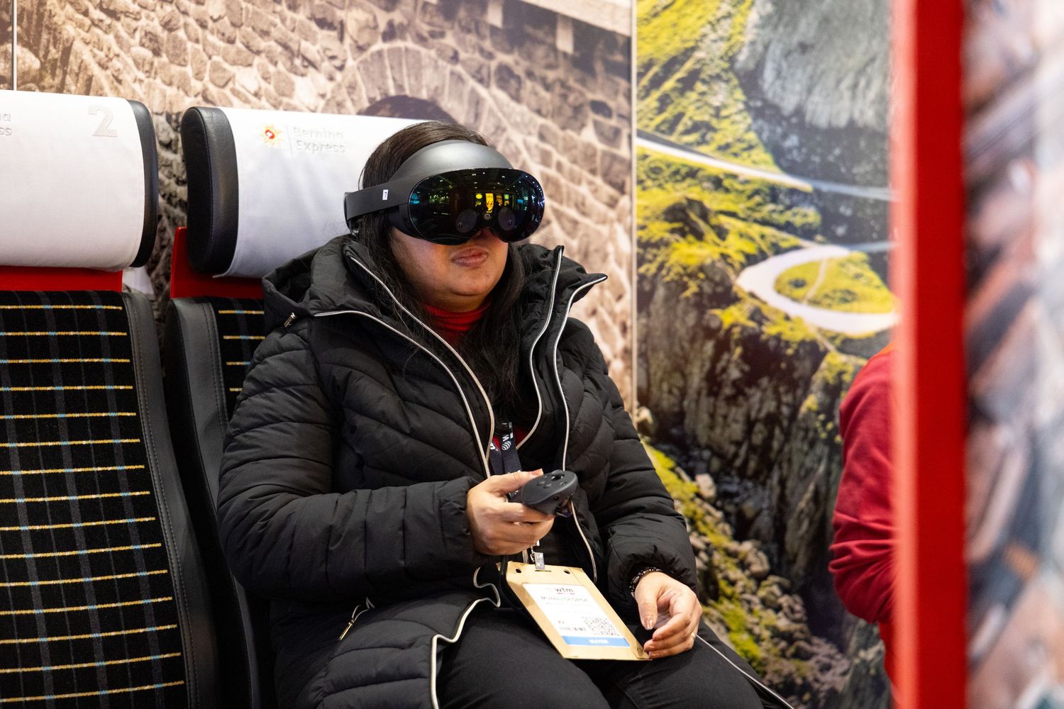 Delegate using a mixed reality headset during a technology showcase at a corporate conference