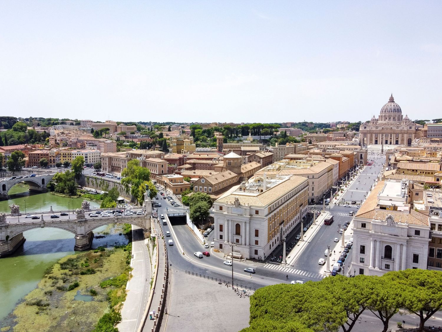 Aerial drone photograph of Rome featuring St Peter’s Basilica, the River Tiber and the historic city skyline on a clear summer day.