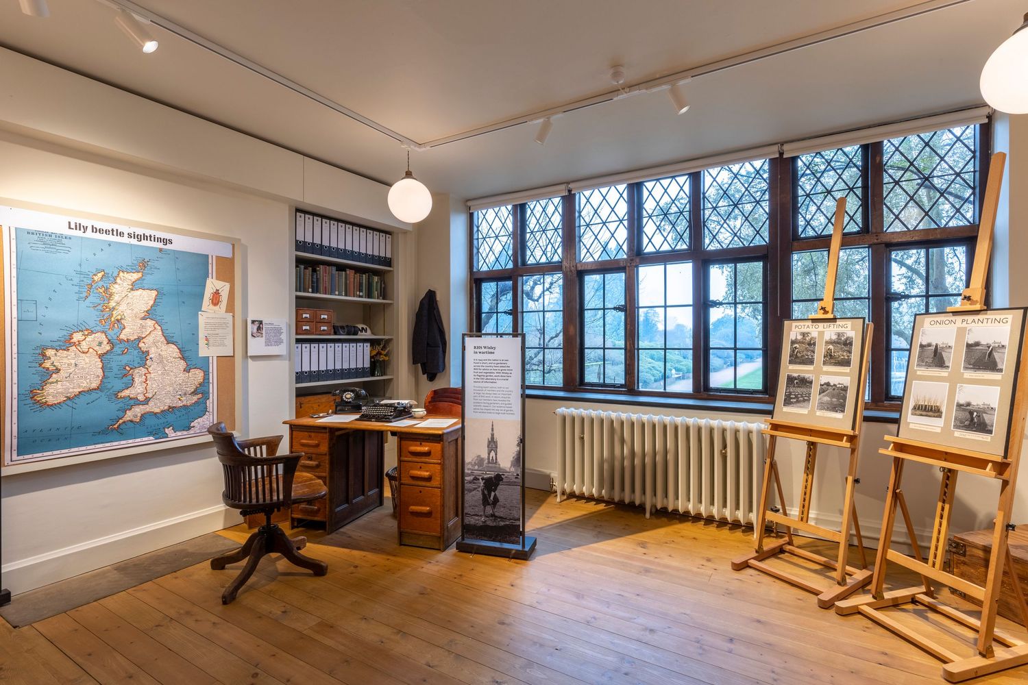 Historic study interior featuring antique furnishings, leaded windows and traditional British architectural character.