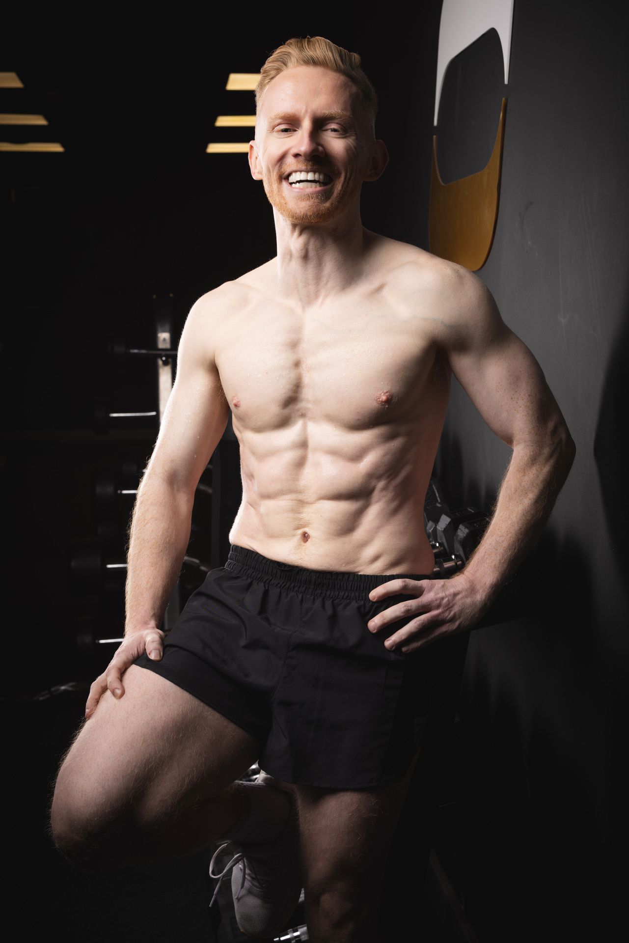 A dramatic fitness photo showing a muscular male torso shot in a Hertfordshire gym.