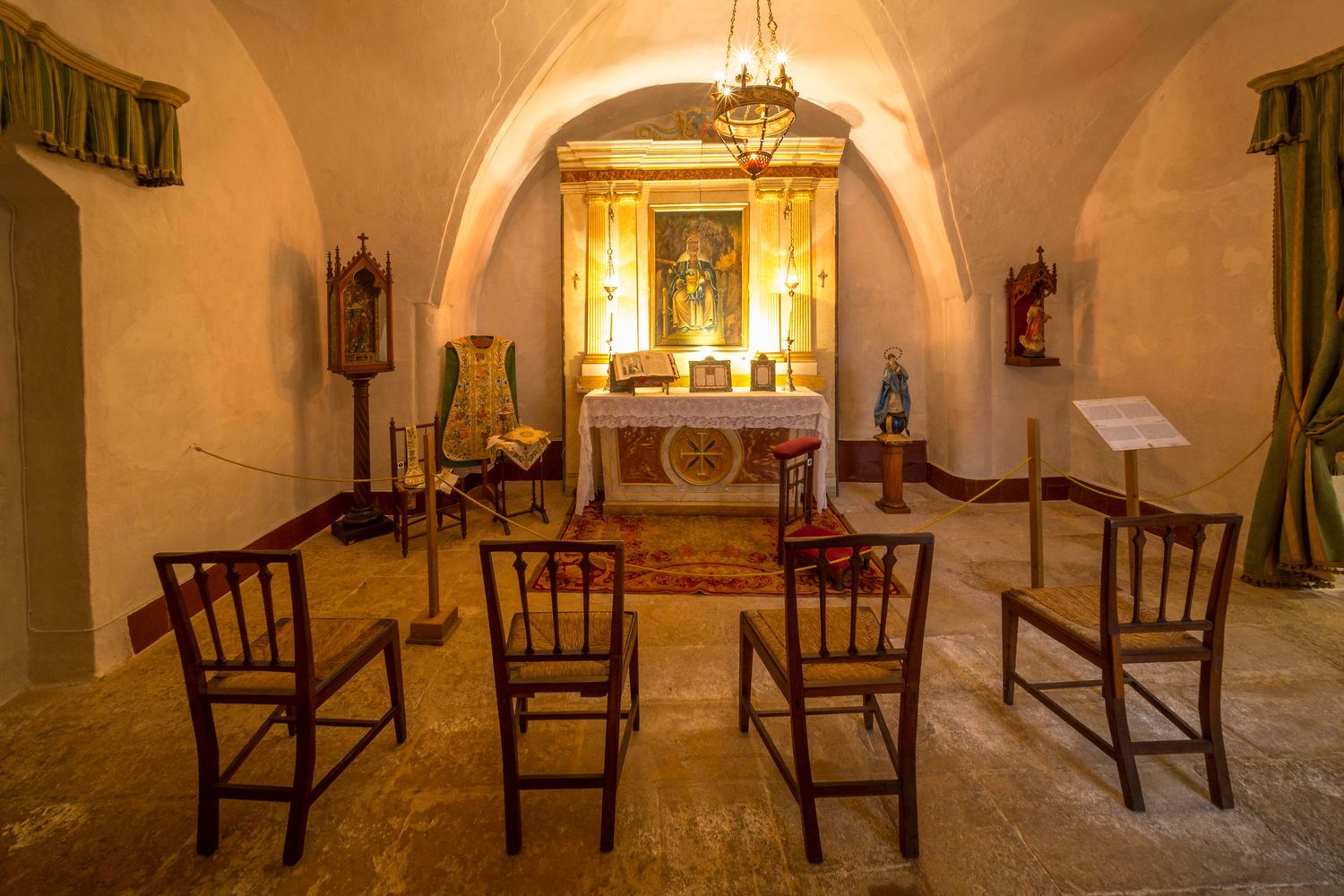 Historic chapel interior featuring ornate altar, religious artwork and architectural details photographed for heritage marketing.