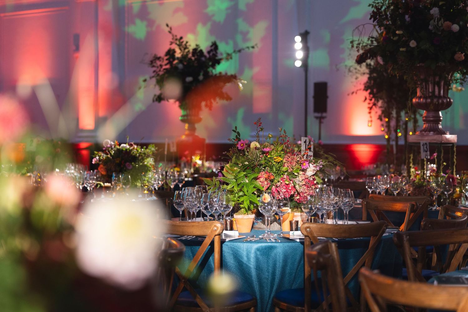Elegant venue prepared for a corporate awards ceremony with formal dining tables and ambient event lighting