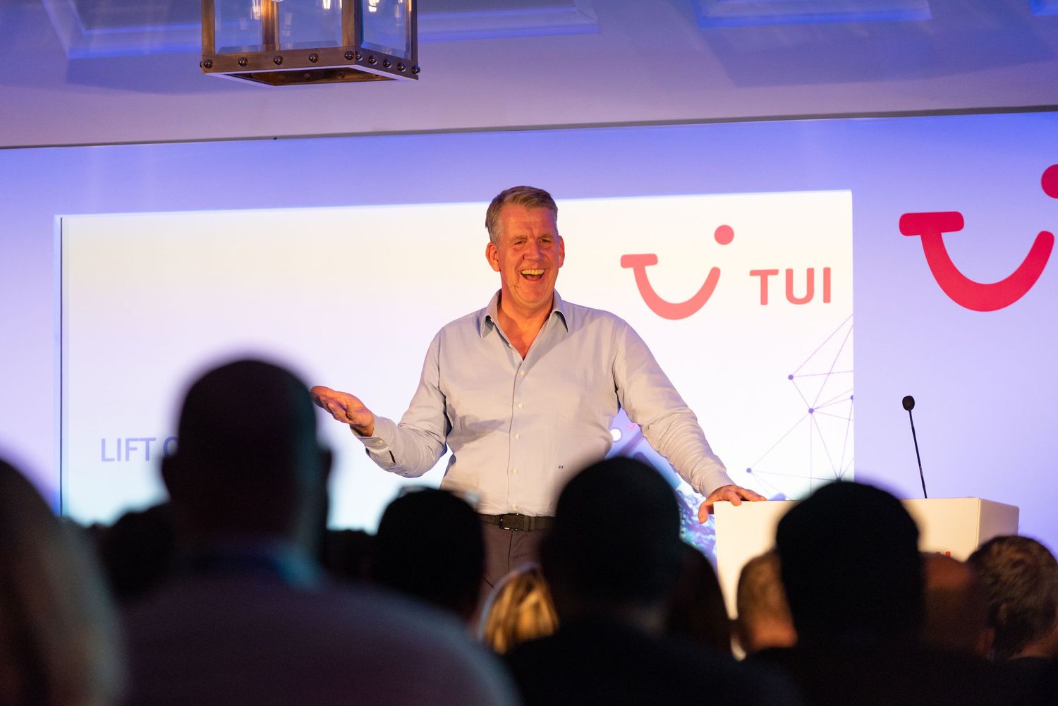 Conference speaker presenting on stage at a TUI corporate event during business conference in the UK