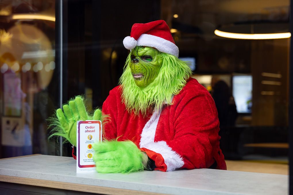 The Grinch mascot waiting for food at the McDonald’s Rickmansworth restaurant opening, photographed for PR and press use.