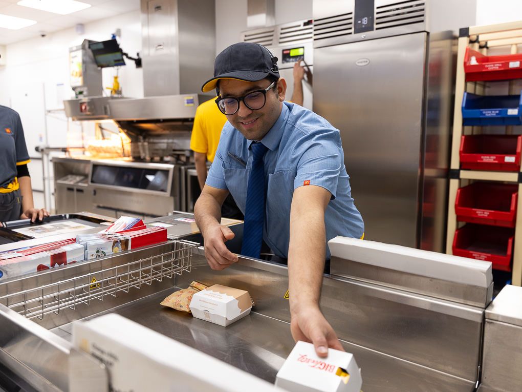 McDonald’s crew member preparing burgers at the Rickmansworth restaurant opening, photographed for PR and press use in the kitchen.