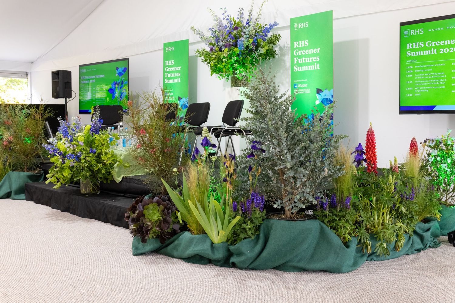 RHS Greener Future Summit stage featuring sustainable planting displays during a business conference event