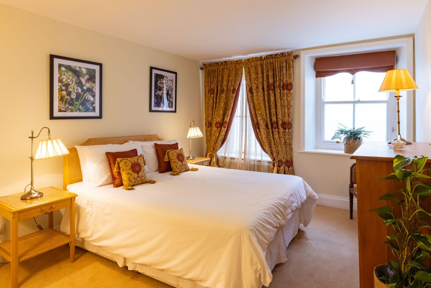 Luxury hotel bedroom with elegant furnishings, warm lighting and premium hospitality interior design.