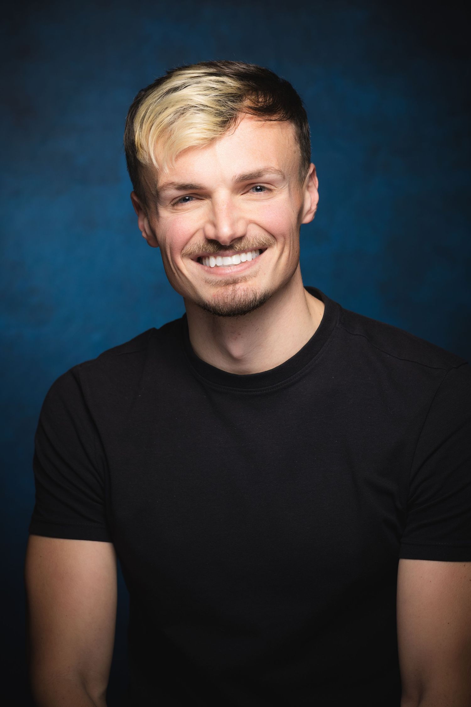 Actor headshots with different expressions photographed against blue studio backdrop at Castle Theatre Wellingborough
