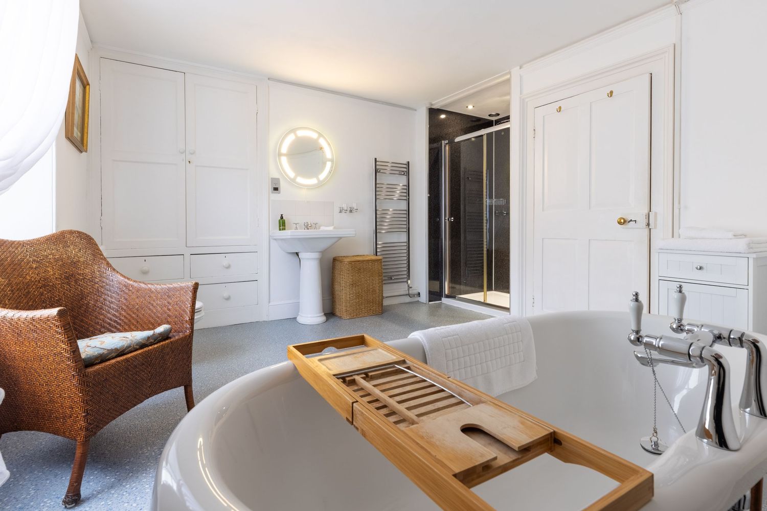 Luxury bathroom with freestanding bath, walk-in shower and contemporary interior design for property photography.