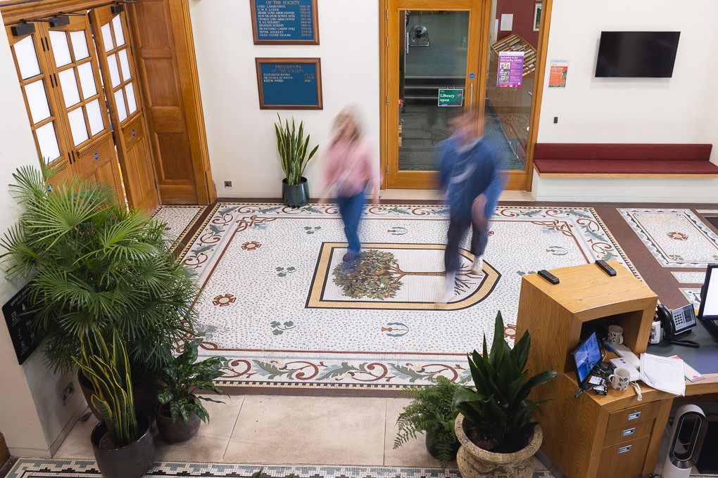 A staff photo shoot where colleagues walk through the foyer of the RHS's office in Victoria, London.