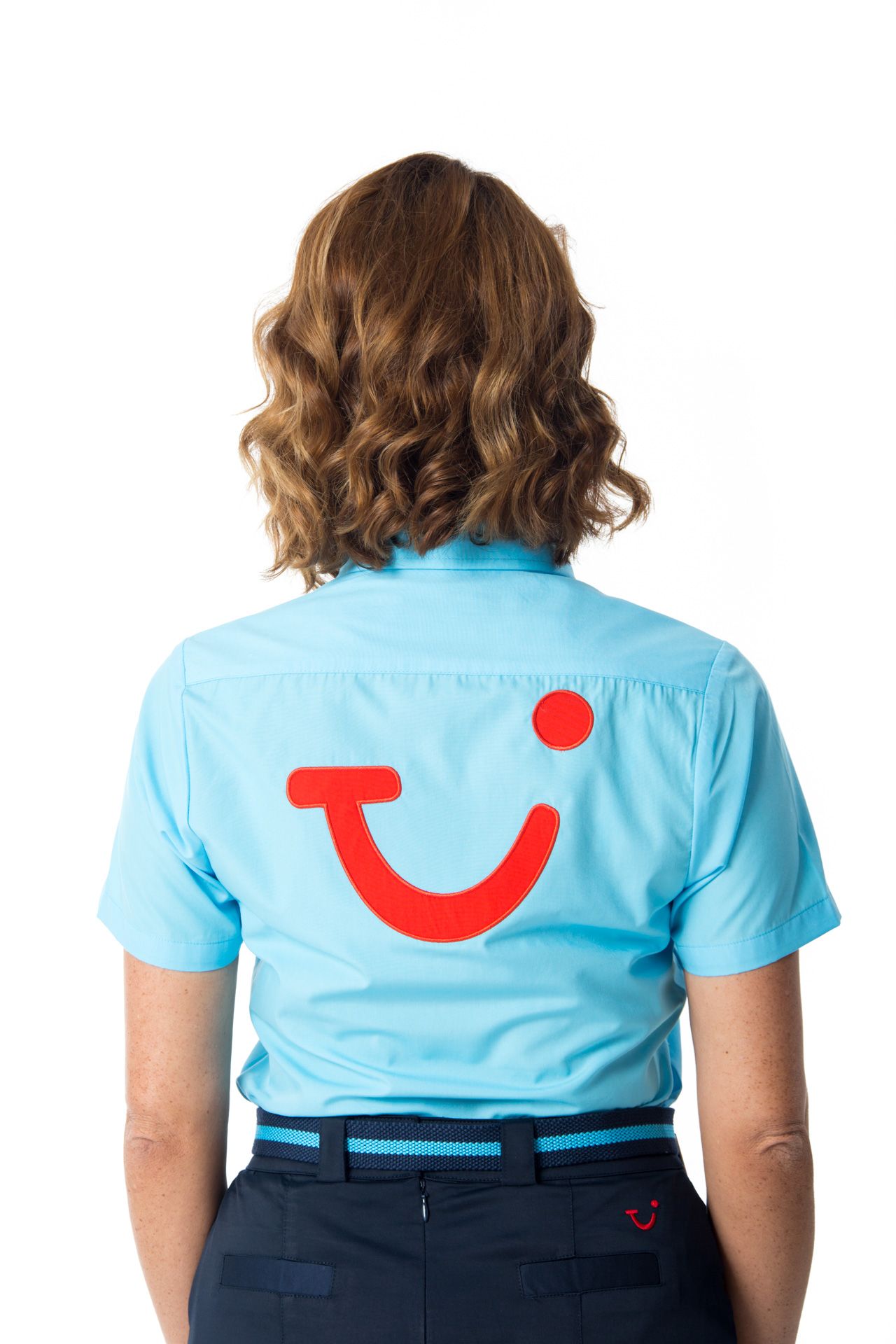 Back view of a blue uniform shirt with red TUI smile logo and wavy brown hair against white background.