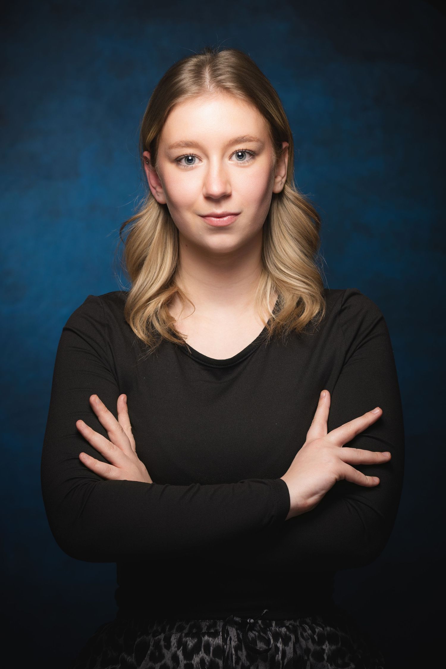 Actor headshot portrait with expressive poses photographed against blue studio backdrop at Castle Theatre Wellingborough
