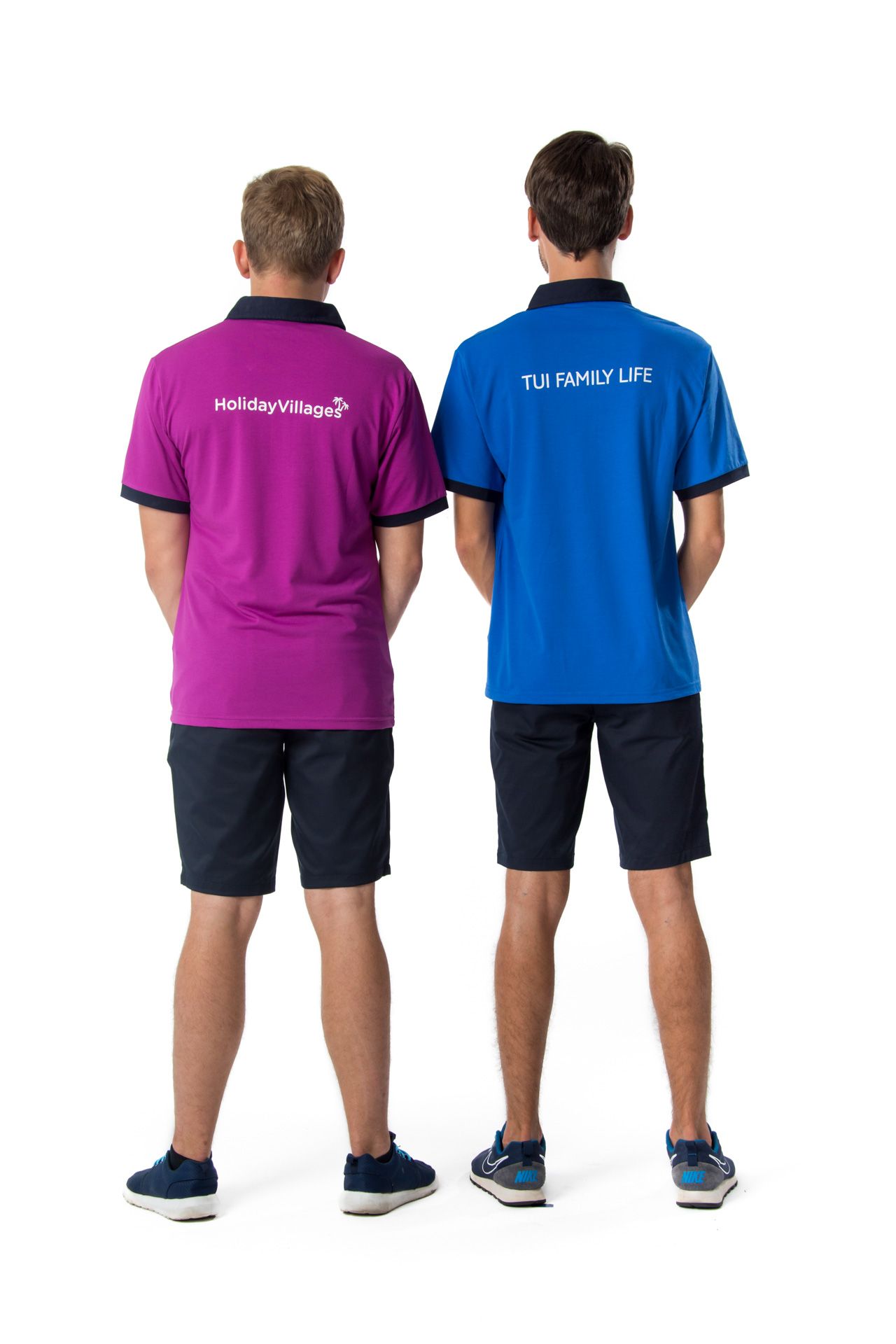 Two people in polo shirts reading 'TUI FAMILY LIFE' and 'HelloHoliday' stand with backs turned wearing navy shorts.