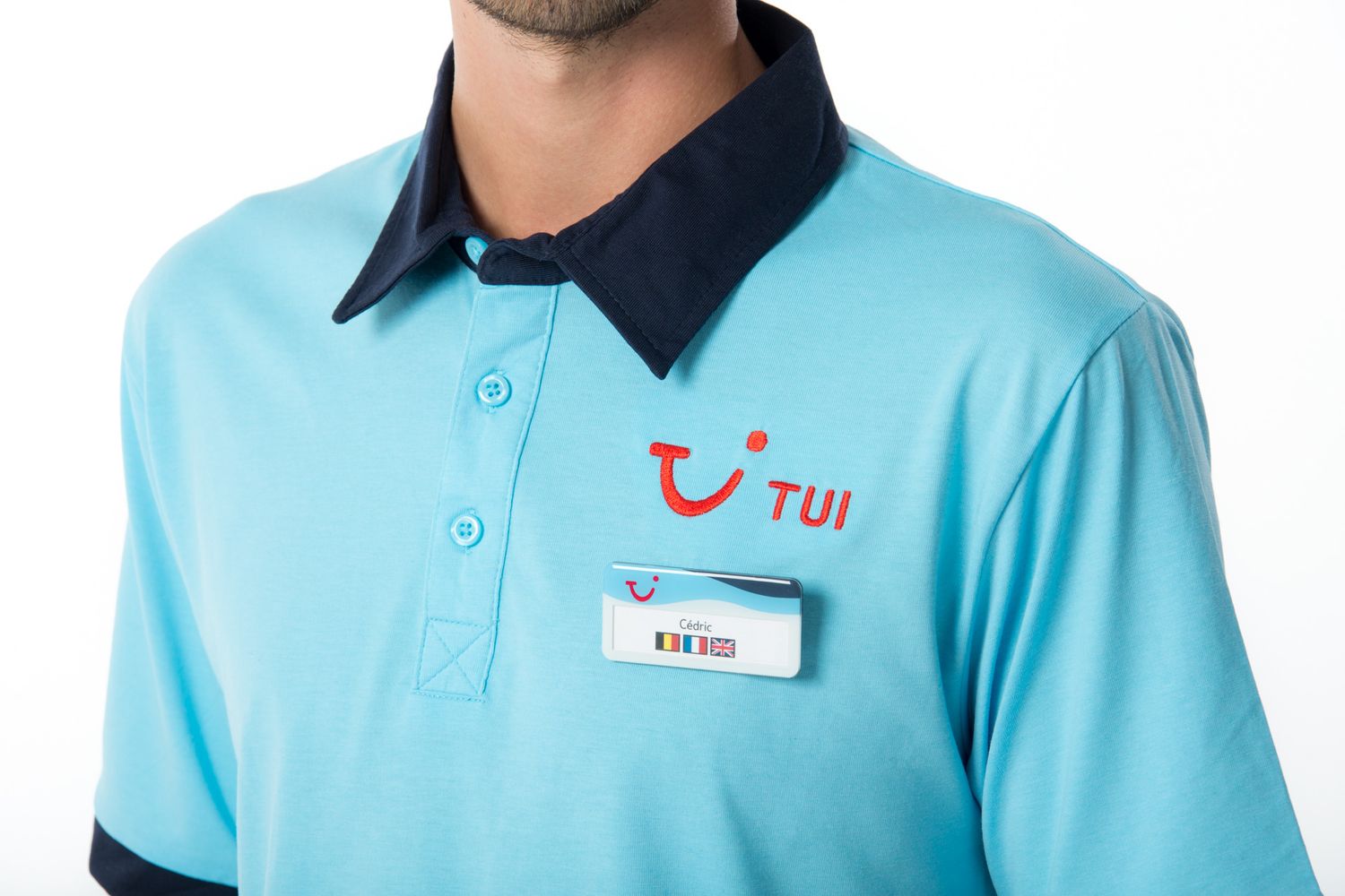 TUI employee uniform polo shirt in light blue with navy collar and red company TUI Smile logo on chest.