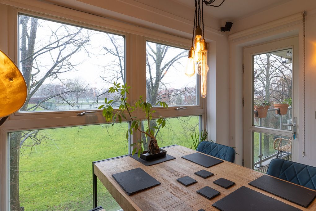 Interior photography of a modern luxury apartment with large windows overlooking the green hills of Hertfordshire.