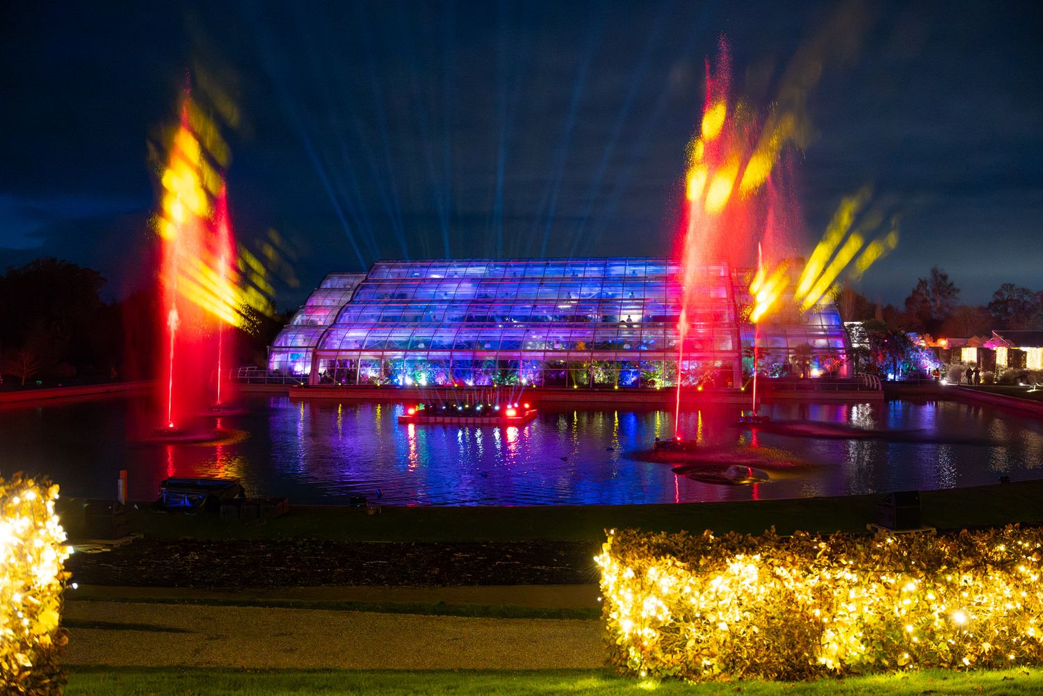Light trail photography of the glasshouse and lake at RHS Wisley during their Glow event.