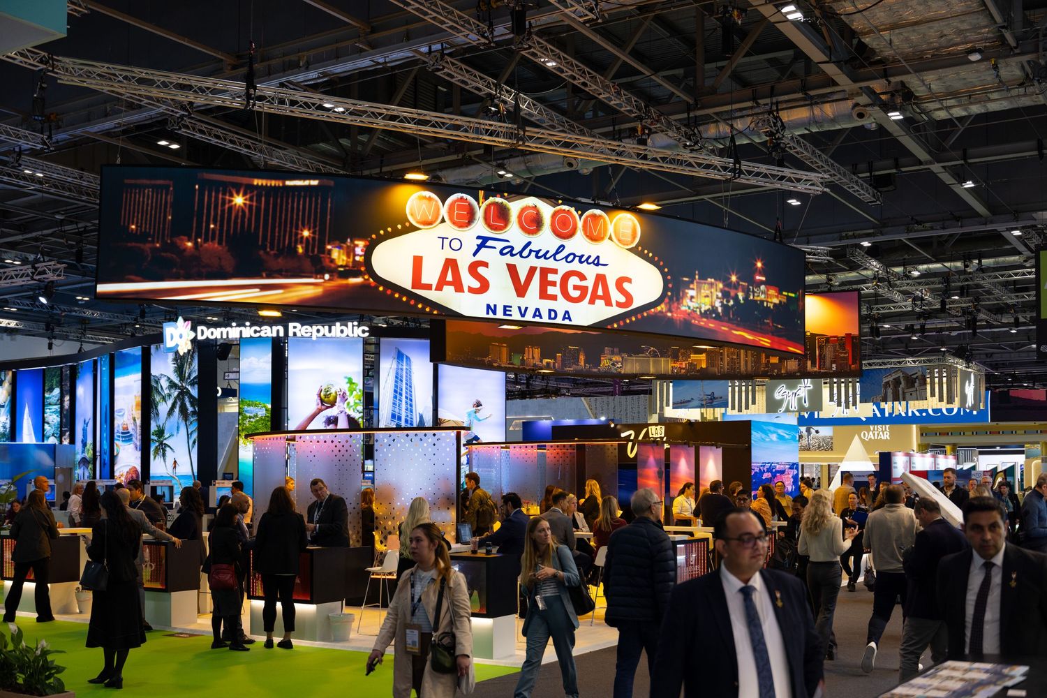 Busy Las Vegas Nevada themed exhibition booth at a trade show with crowds of visitors exploring displays.