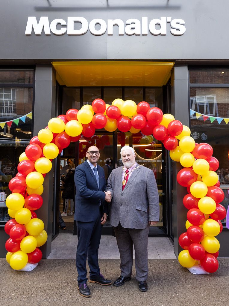 McDonald’s restaurant entrance at the Rickmansworth opening, photographed for PR and press use with festive red and yellow balloon arch.