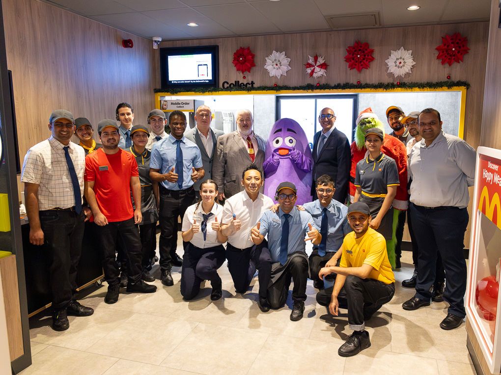 McDonald’s restaurant staff posing together at the Rickmansworth opening, photographed for press and PR use against a branded interior.