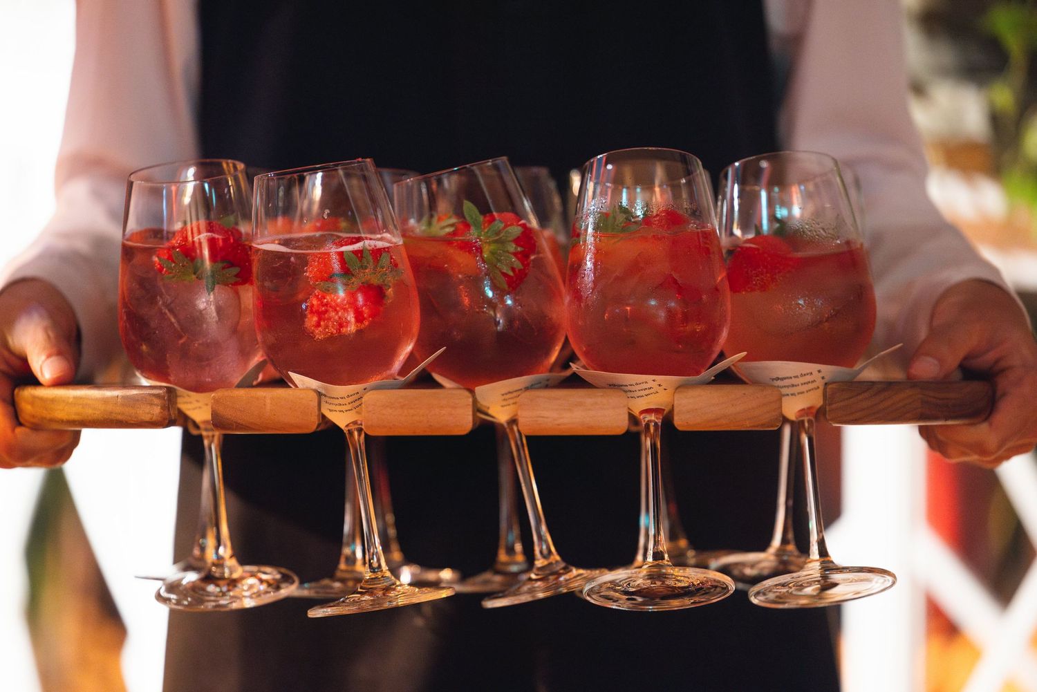Waiter serving cocktails during a corporate event reception and networking session