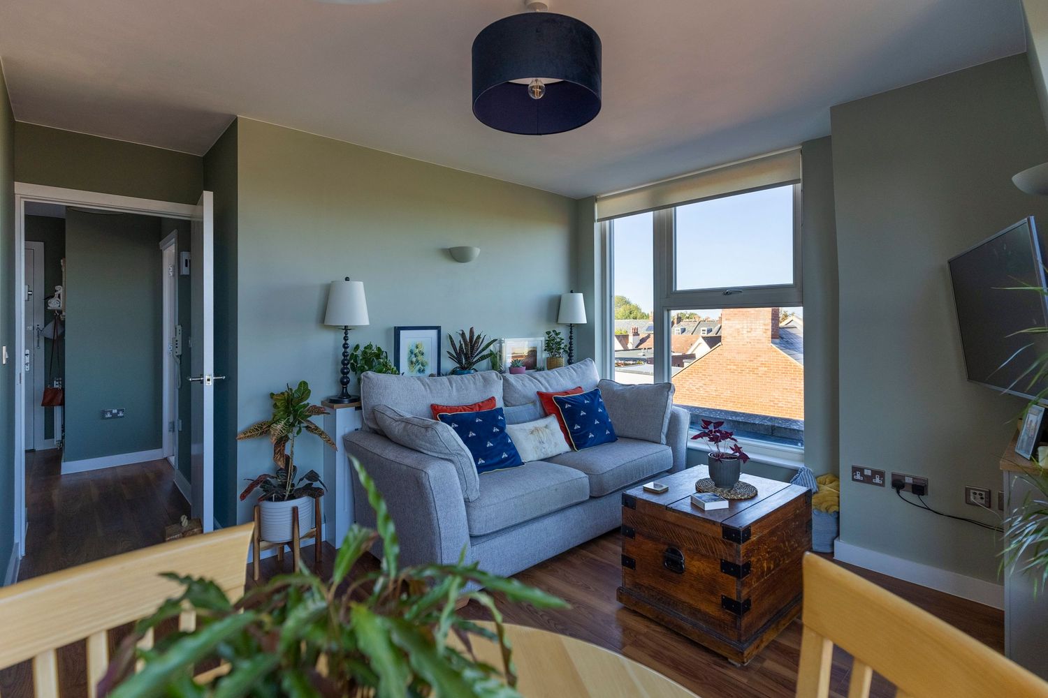 Modern living room with contemporary furnishings, natural light and stylish interior design for property photography.