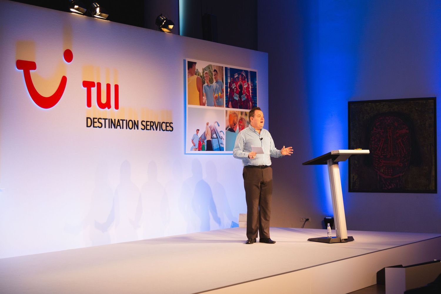 Presenter speaking on stage at a TUI Destination Services corporate conference and business event
