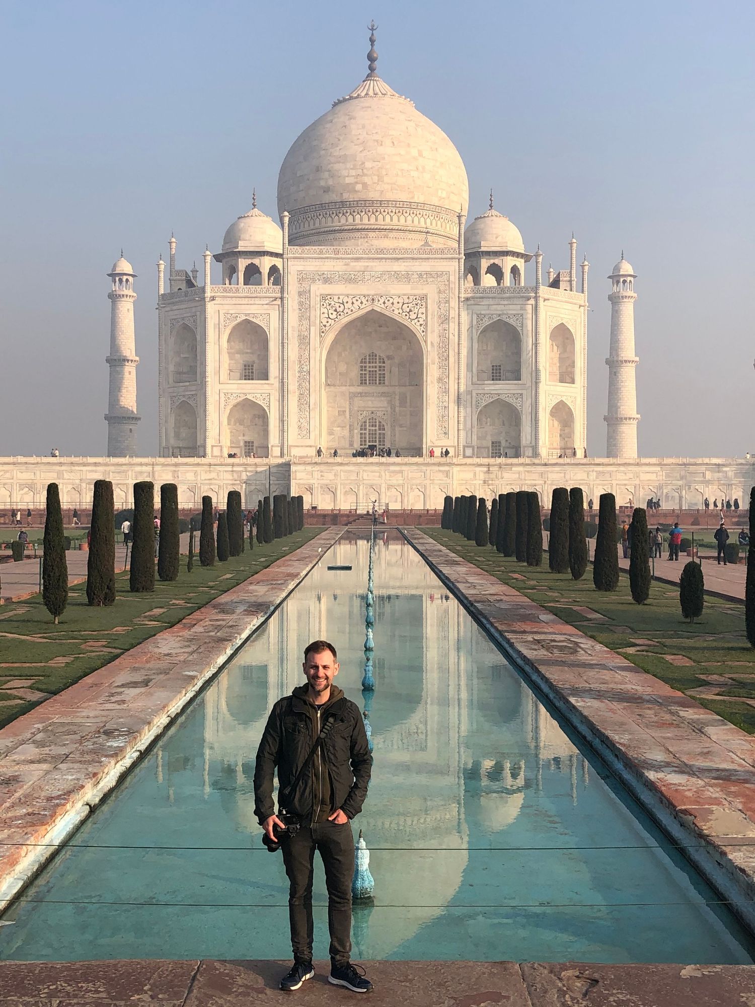 Lee Charlton standing in front of the Taj Mahal in Agra, India during his international travel photography career.