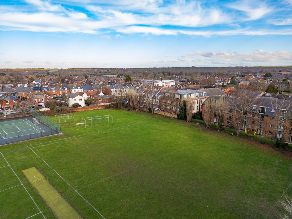 Aerial property photography of a luxury apartment that overlooks green sports fields.
