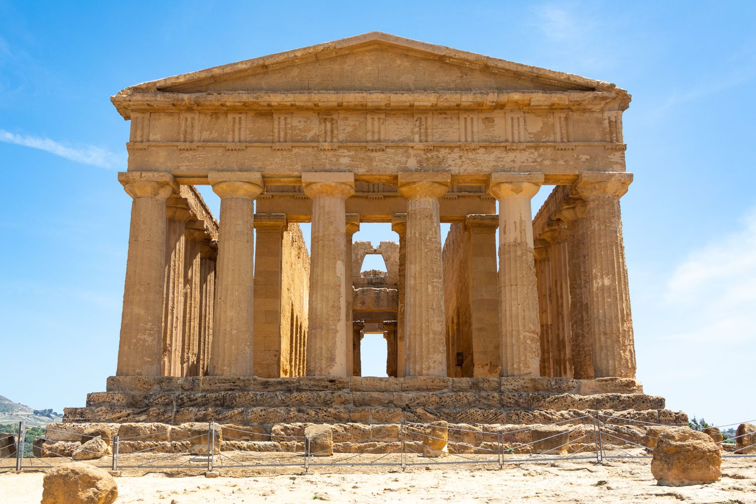 Ancient Greek Temple of Concordia with Doric columns under blue sky in Sicily, Italy.