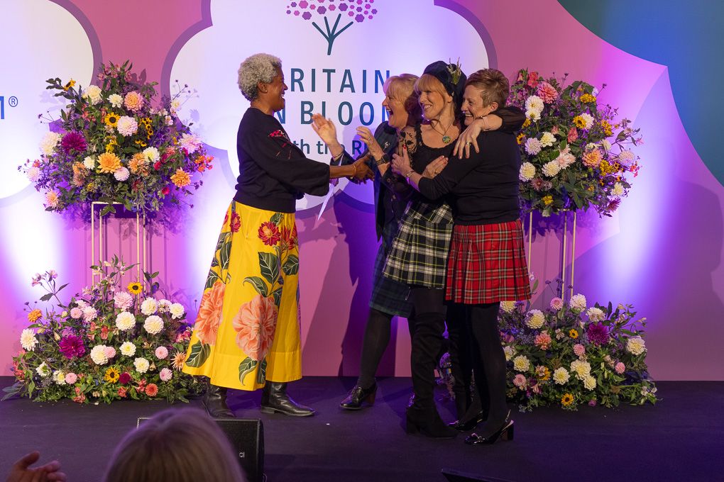 Let’s Get Grangemouth Clean Glitter Team celebrating their award win on stage at the Britain in Bloom Awards 2025.