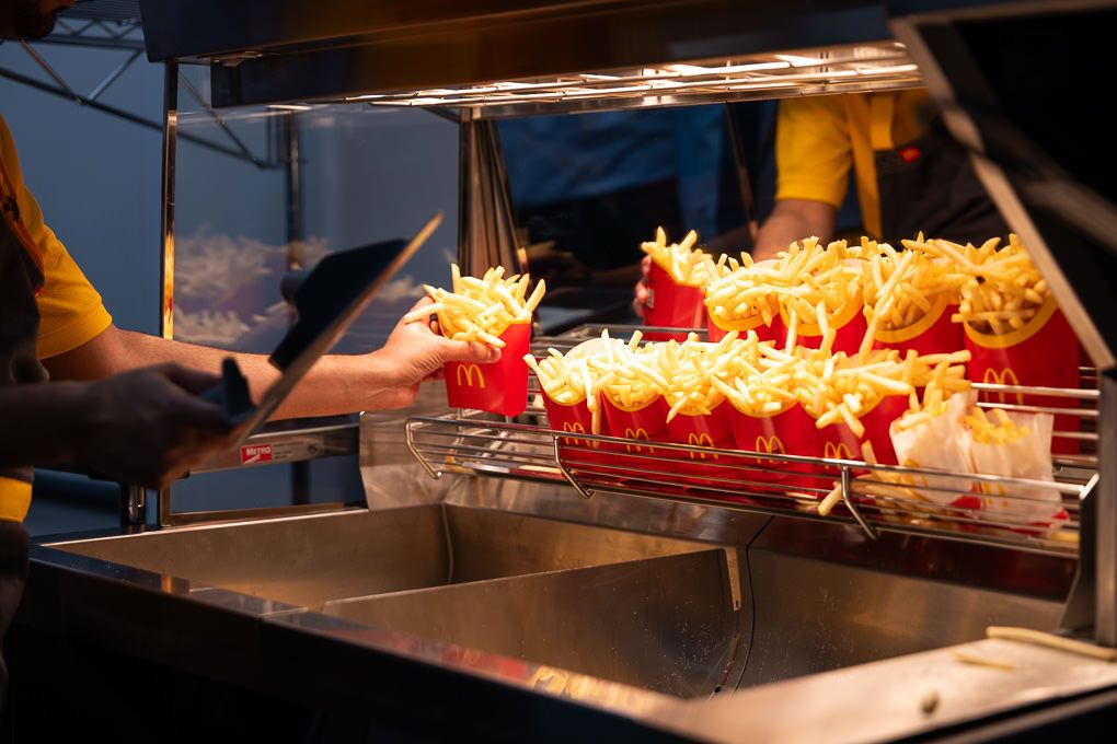 McDonald’s crew member cooking and serving fries at the Rickmansworth restaurant opening, photographed for PR and press use.