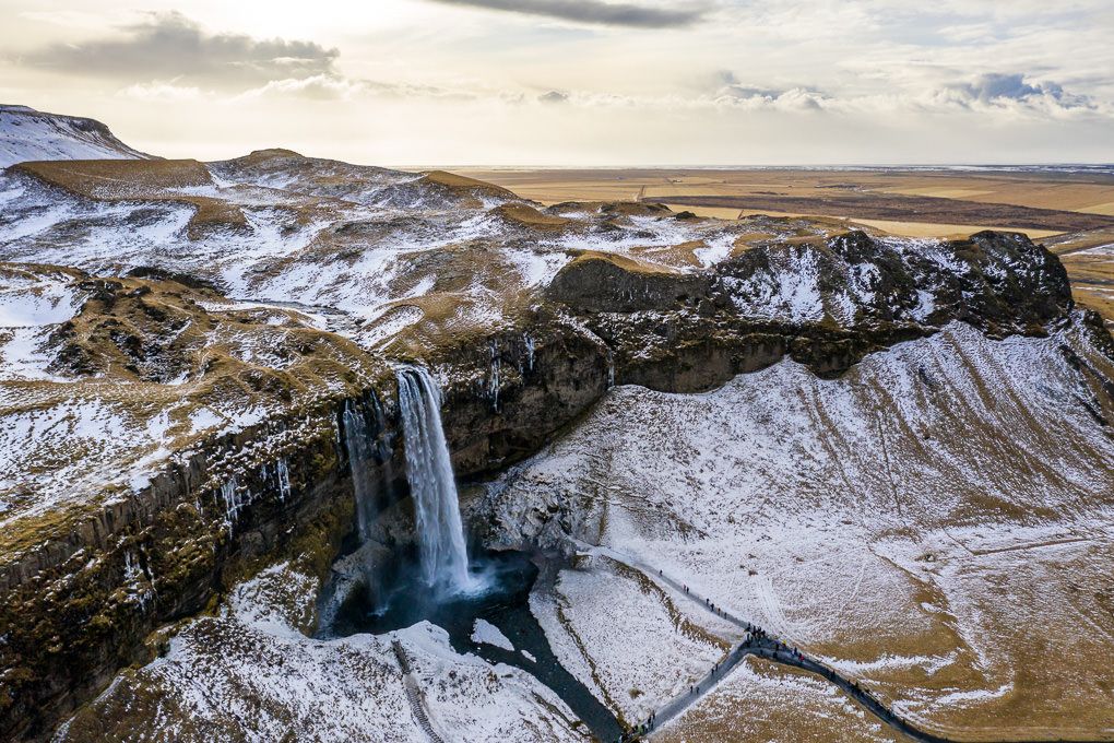 Aerial view of Seljalandsfoss Waterfall with cascading waterfalls in winter.