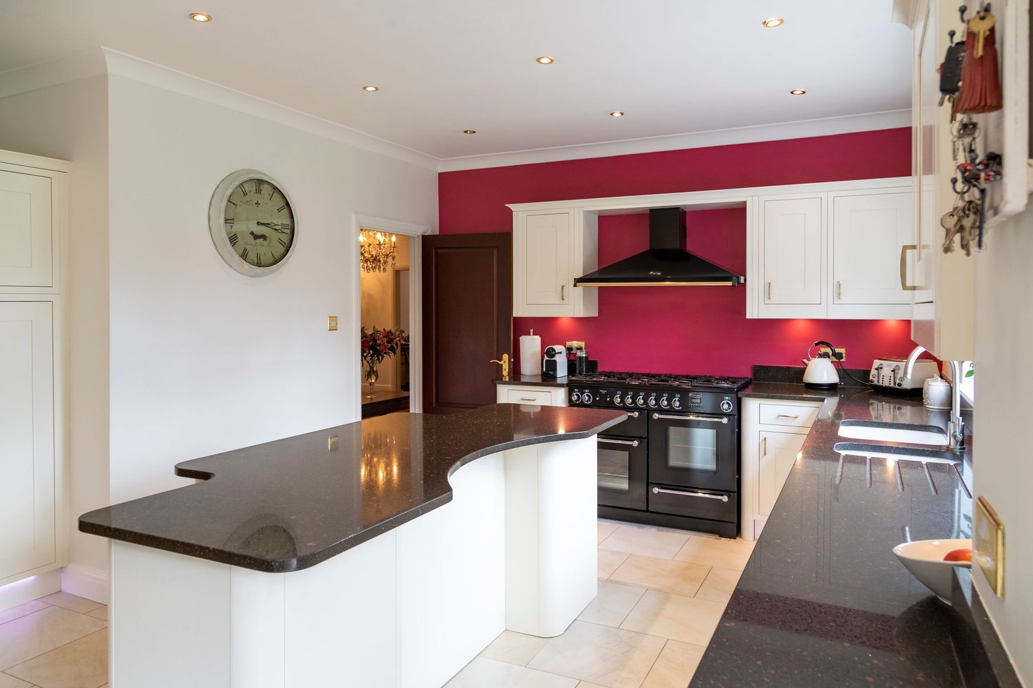 Modern kitchen interior with bespoke cabinetry, granite worktops and premium appliances for property photography.