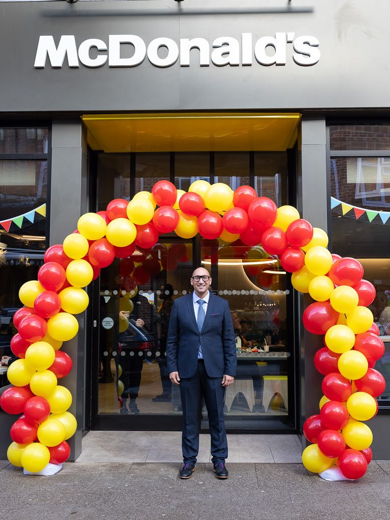 McDonald’s restaurant entrance at the Rickmansworth grand opening, photographed for PR and press use with red and yellow balloon arches.