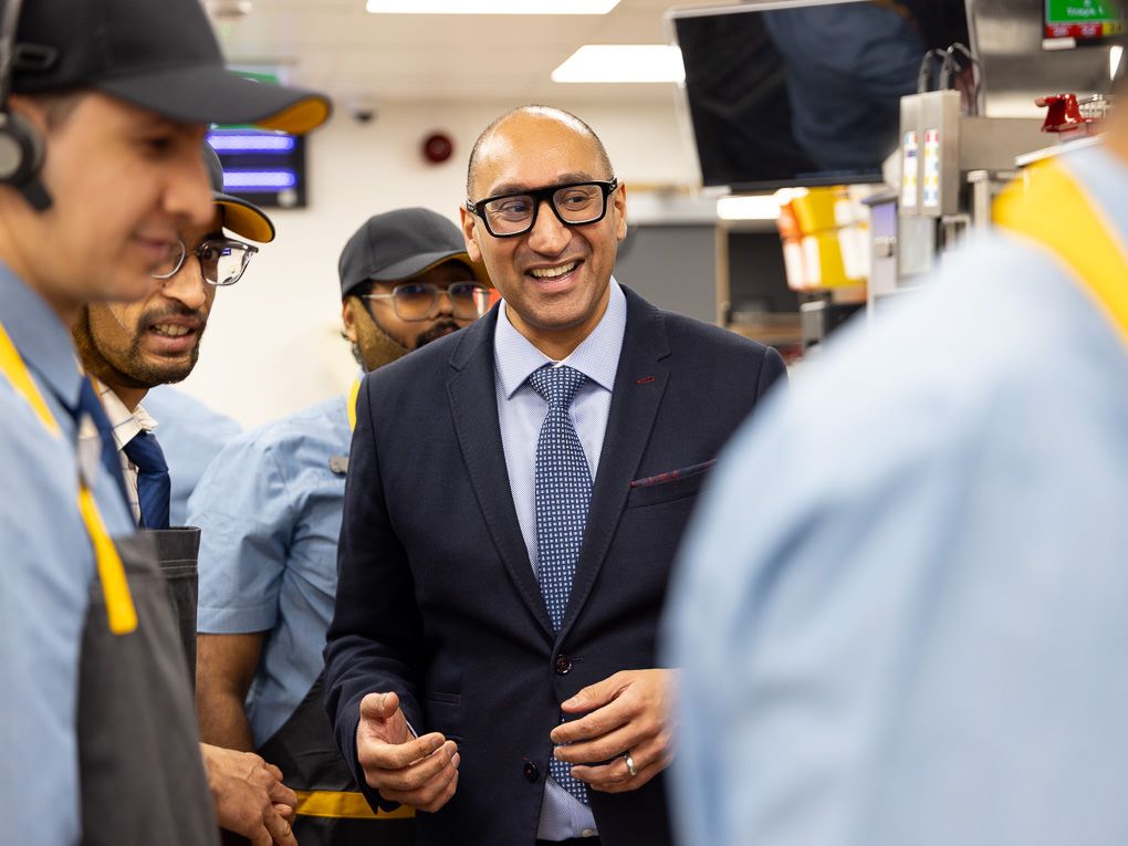 McDonald’s franchisee chatting with kitchen staff at the Rickmansworth restaurant opening, photographed for PR and press use.