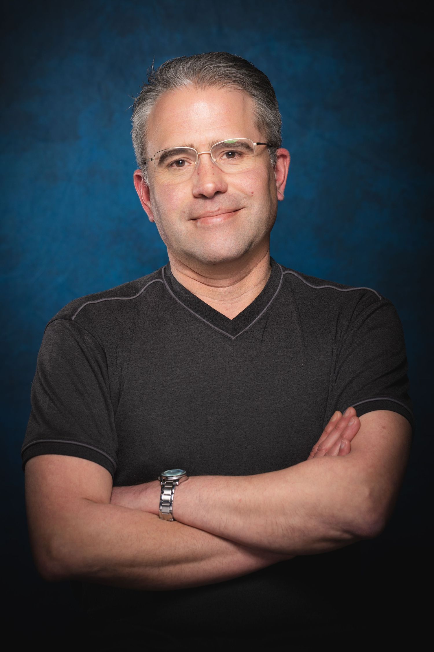 Professional actor headshot portrait series photographed against blue studio backdrop at Castle Theatre Wellingborough
